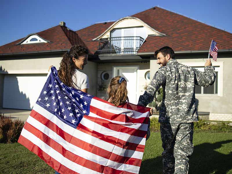 US Military soldier and family happily walking to house